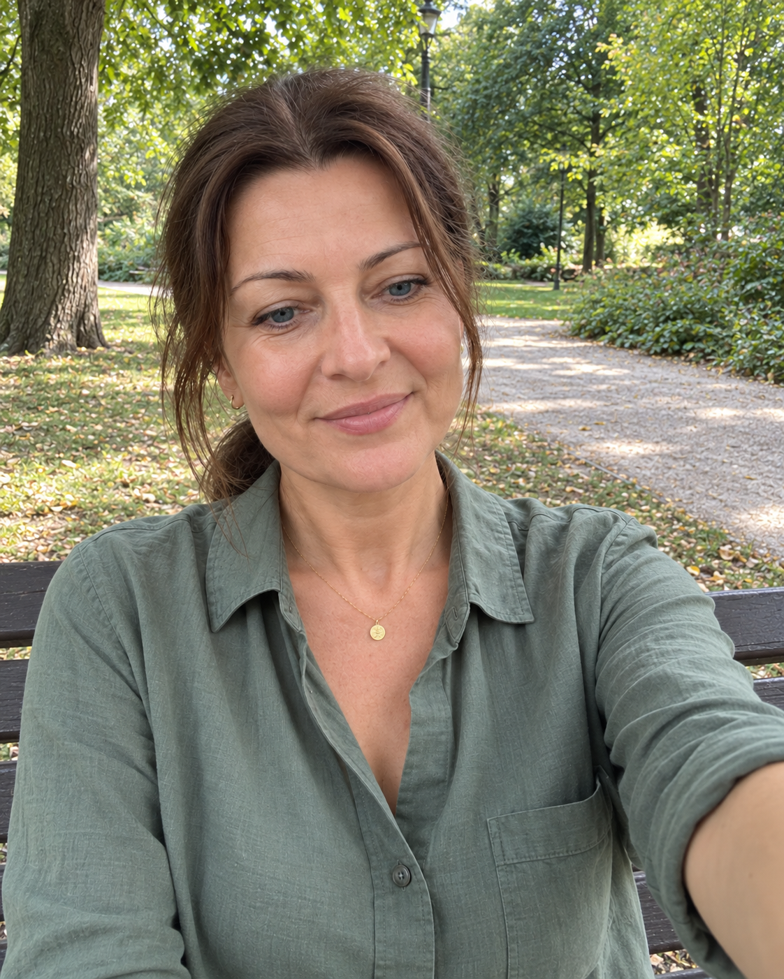 Ilustracyjne zdjęcie fikcyjnej kobiety robiącej selfie w parku, wygenerowane przez AI; nie przedstawia autorki opinii.
